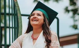 Happy college graduate wearing graduation cap